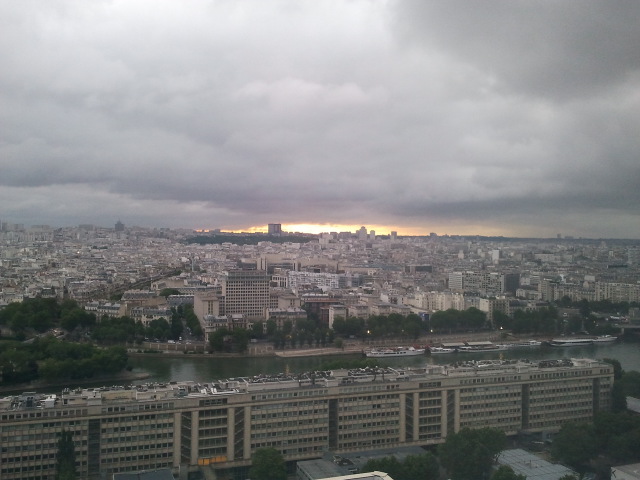 The Sun rises behind the clouds